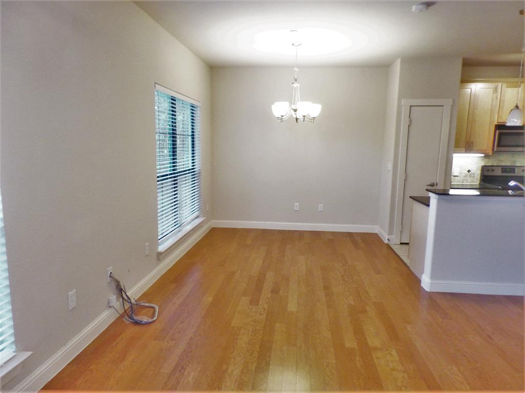 6159 Oram Street, Unit 105 Dallas, TX 75214 - Photo 4 of 16 wooden floor in an empty room with a window