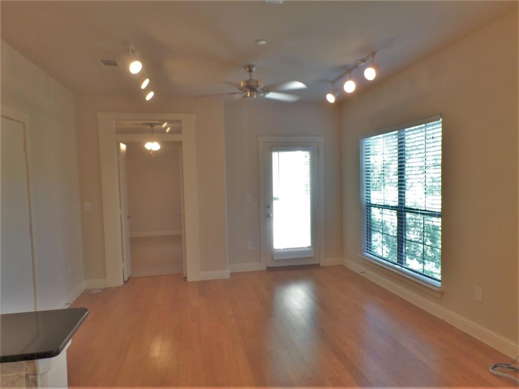 6159 Oram Street, Unit 105 Dallas, TX 75214 - Photo 9 of 16 a view of empty room with wooden floor and fan