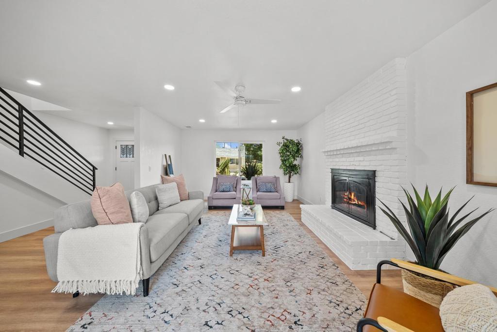 9306 Hollyhock Lane Spring Valley, CA 91977 - Photo 12 of 61 a living room with furniture fireplace and potted plant