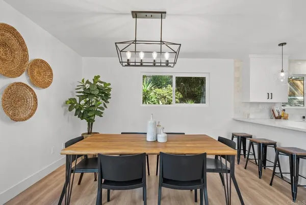 a kitchen with stainless steel appliances a sink a stove a refrigerator cabinets and a window