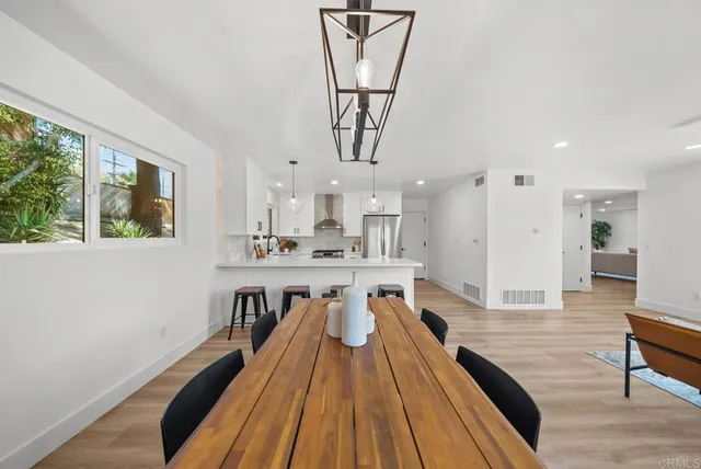 a kitchen with stainless steel appliances a sink stove and refrigerator