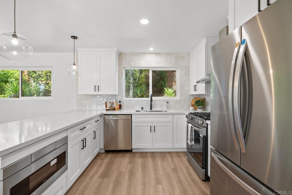 9306 Hollyhock Lane Spring Valley, CA 91977 - Photo 32 of 61 a kitchen with a sink stainless steel appliances and window