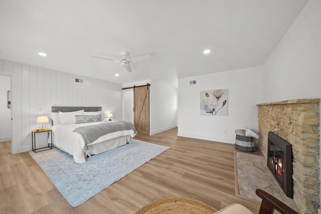 9306 Hollyhock Lane Spring Valley, CA 91977 - Photo 38 of 61 a spacious bedroom with a bed and a fireplace