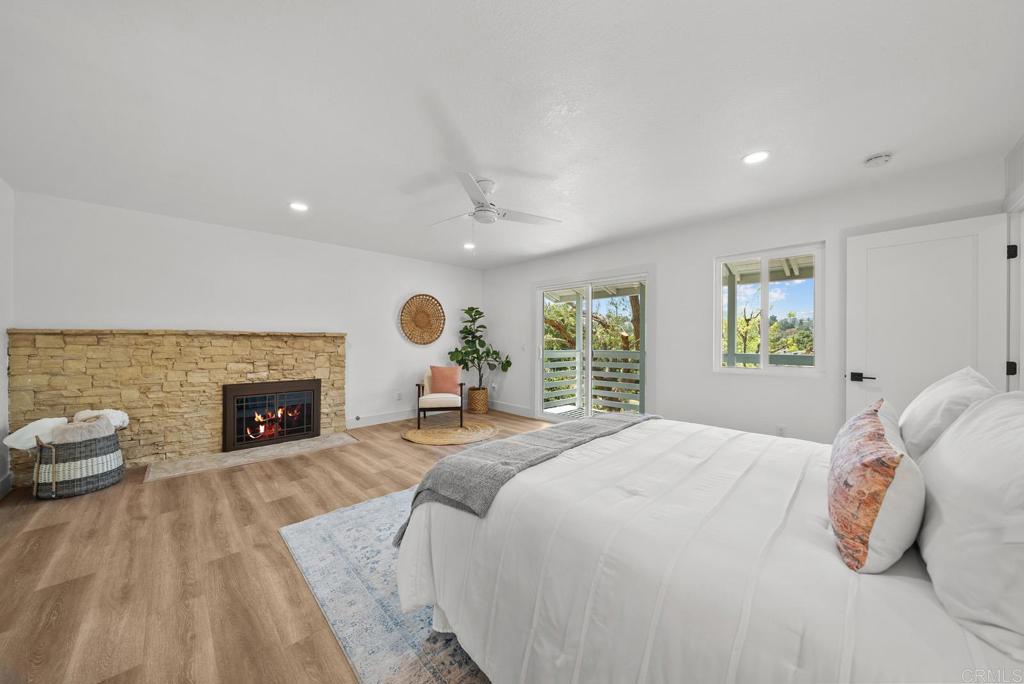 9306 Hollyhock Lane Spring Valley, CA 91977 - Photo 40 of 61 a spacious bedroom with a bed and a fireplace