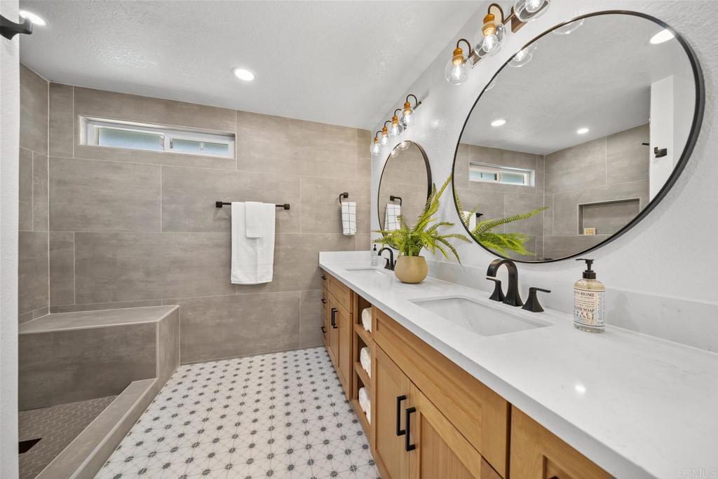 9306 Hollyhock Lane Spring Valley, CA 91977 - Photo 43 of 61 a bathroom with a double vanity sink mirror and shower