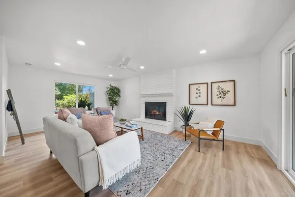 a living room with furniture and a fireplace