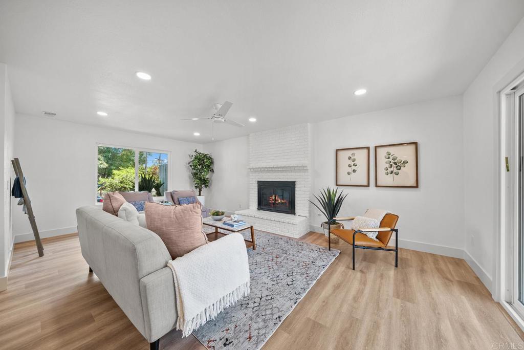 9306 Hollyhock Lane Spring Valley, CA 91977 - Photo 8 of 61 a living room with furniture and a fireplace