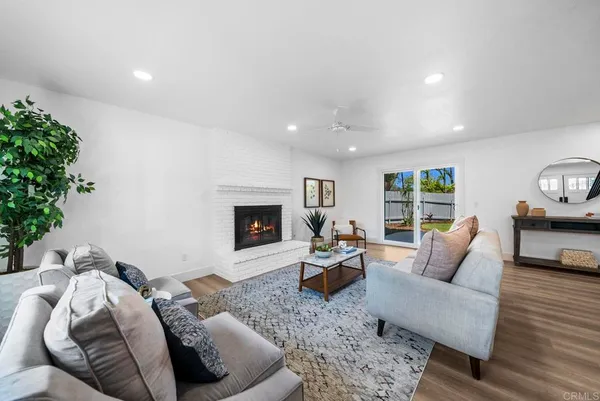 a living room with furniture fireplace and potted plant