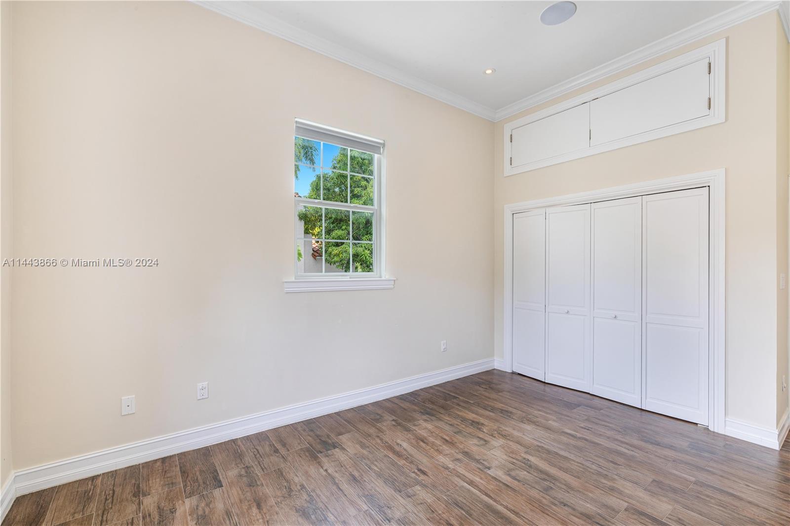 4531 North Bay Road Miami Beach, FL 33140 - Photo 23 of 40 an empty room with wooden floor and windows