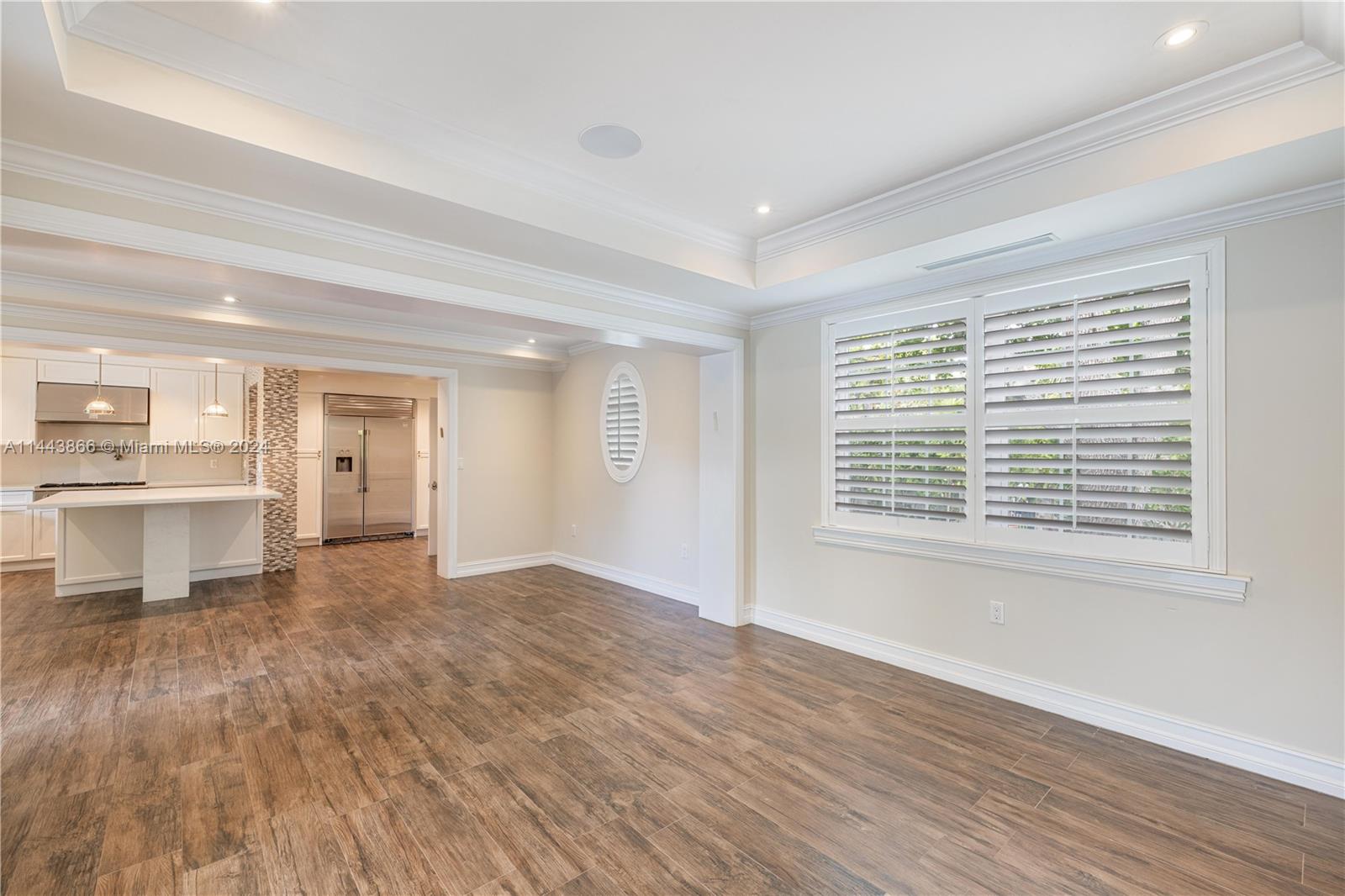 4531 North Bay Road Miami Beach, FL 33140 - Photo 6 of 40 a view of an empty room with wooden floor and a window
