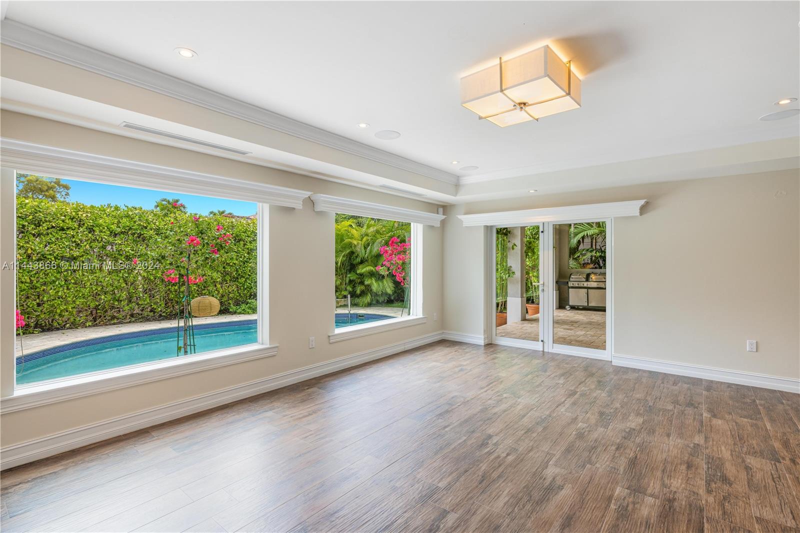 4531 North Bay Road Miami Beach, FL 33140 - Photo 8 of 40 an empty room with wooden floor and windows