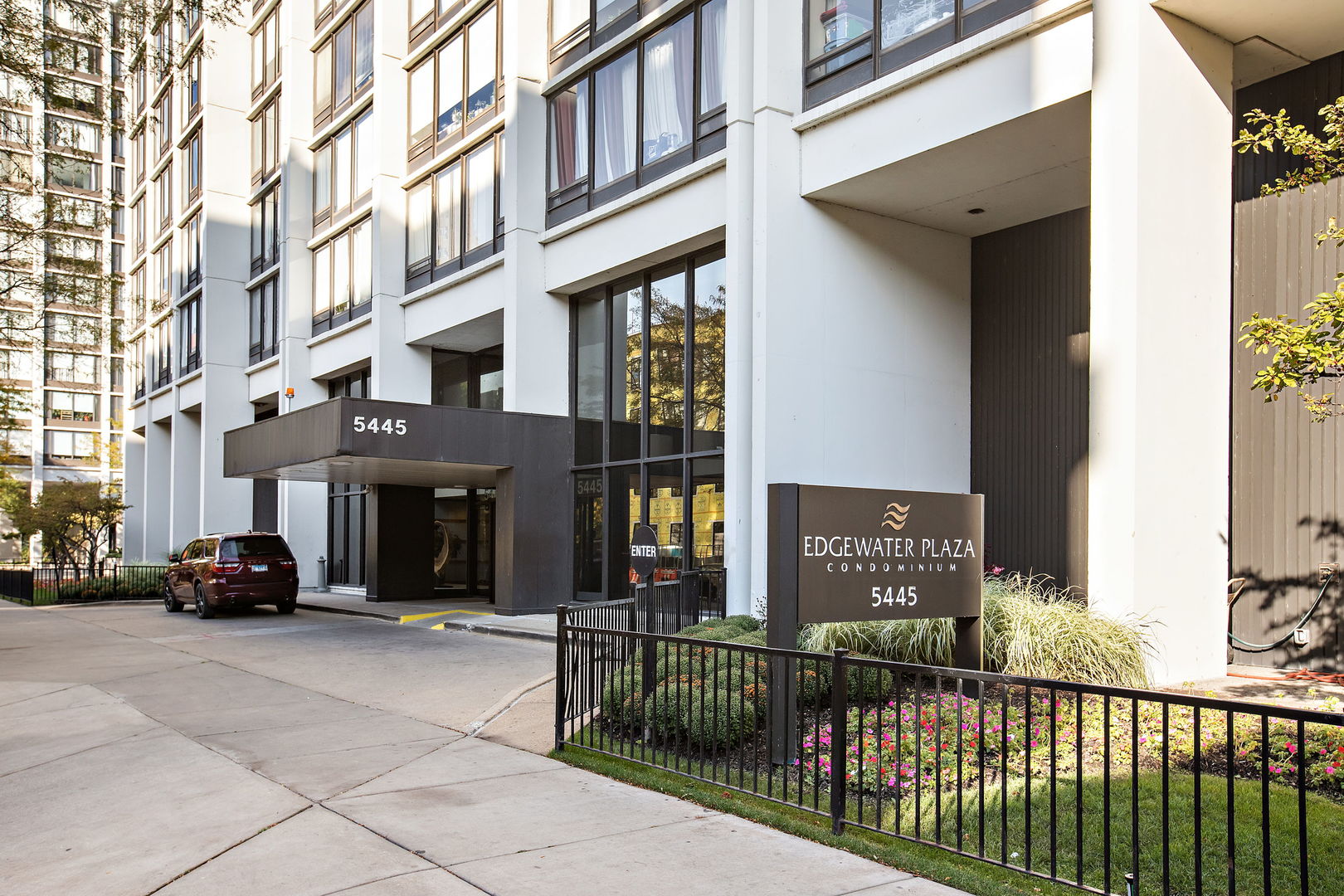 a view of building with car parked