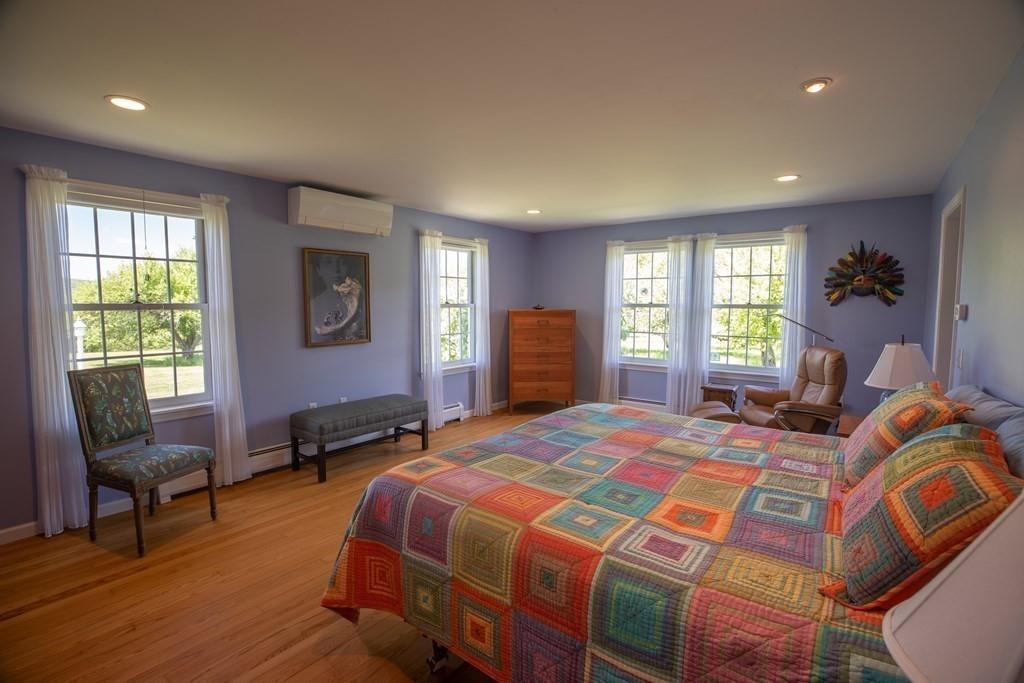 411 West Leyden Road Leyden, MA 01337 - Photo 22 of 42 a bedroom with a bed and wooden floor