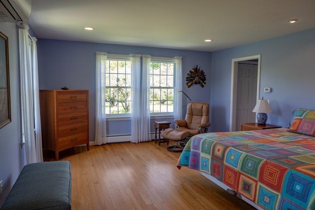411 West Leyden Road Leyden, MA 01337 - Photo 24 of 42 a bedroom with a bed and wooden floor