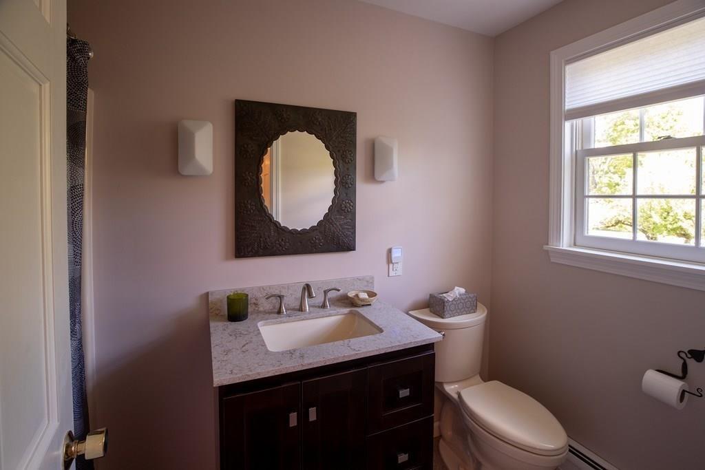 411 West Leyden Road Leyden, MA 01337 - Photo 27 of 42 a bathroom with a granite countertop toilet sink and mirror