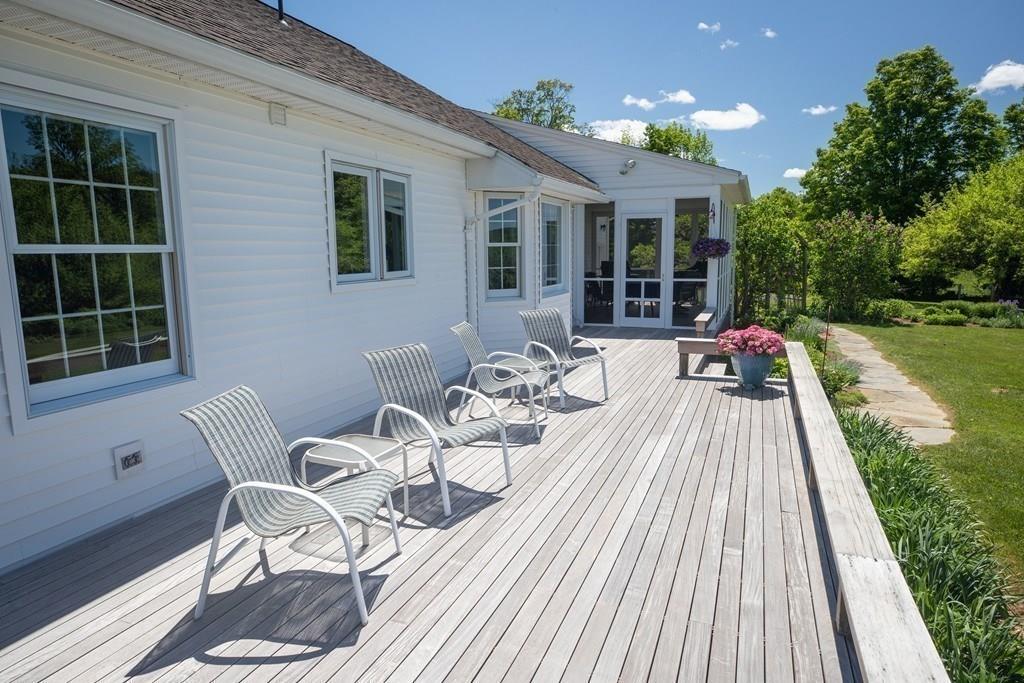 411 West Leyden Road Leyden, MA 01337 - Photo 5 of 42 a view of a patio with table and chairs with wooden floor and fence