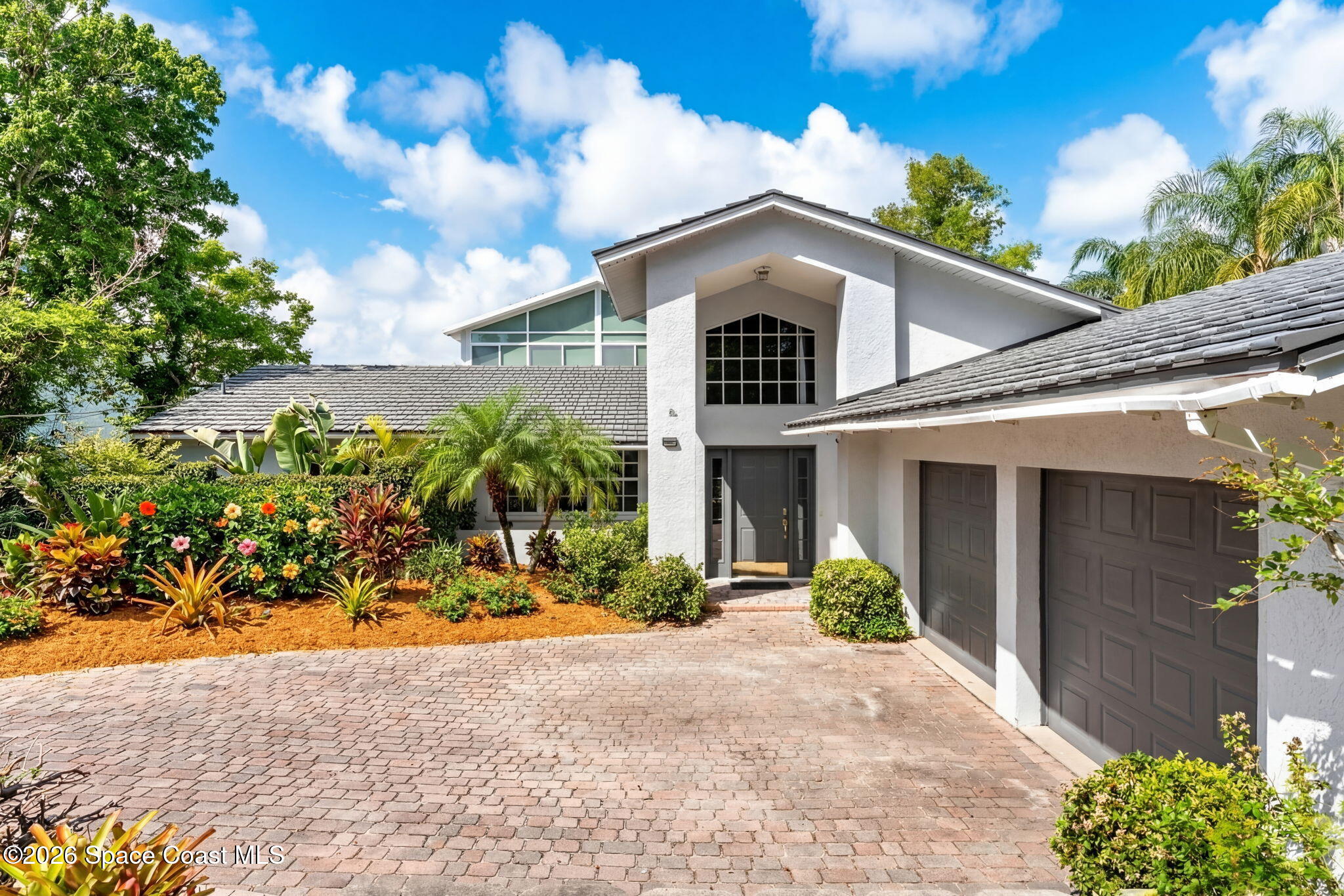975 Oak Street Merritt Island, FL 32953 - Photo 1 of 76 a front view of a house with a yard and garage