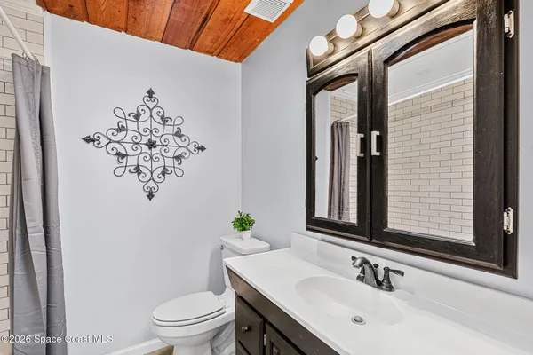 a large bed sitting in a room next to a window