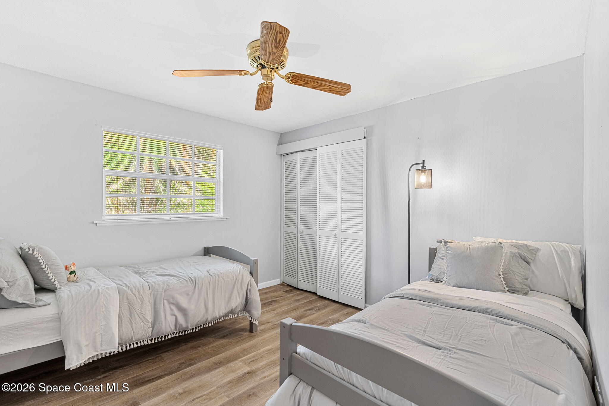 975 Oak Street Merritt Island, FL 32953 - Photo 35 of 76 a bedroom with a bed and a chandelier