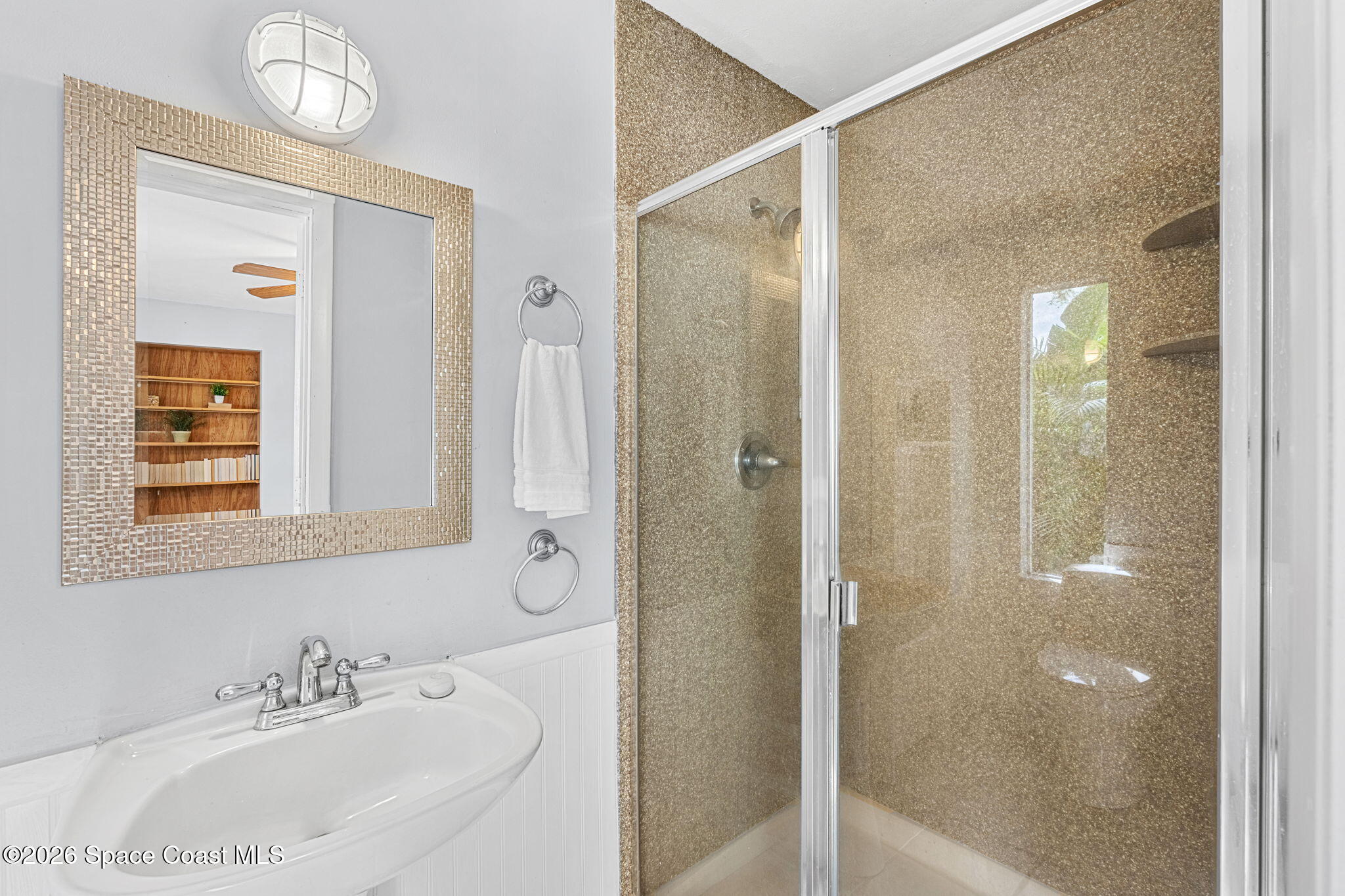 975 Oak Street Merritt Island, FL 32953 - Photo 36 of 76 a bathroom with a sink and a mirror