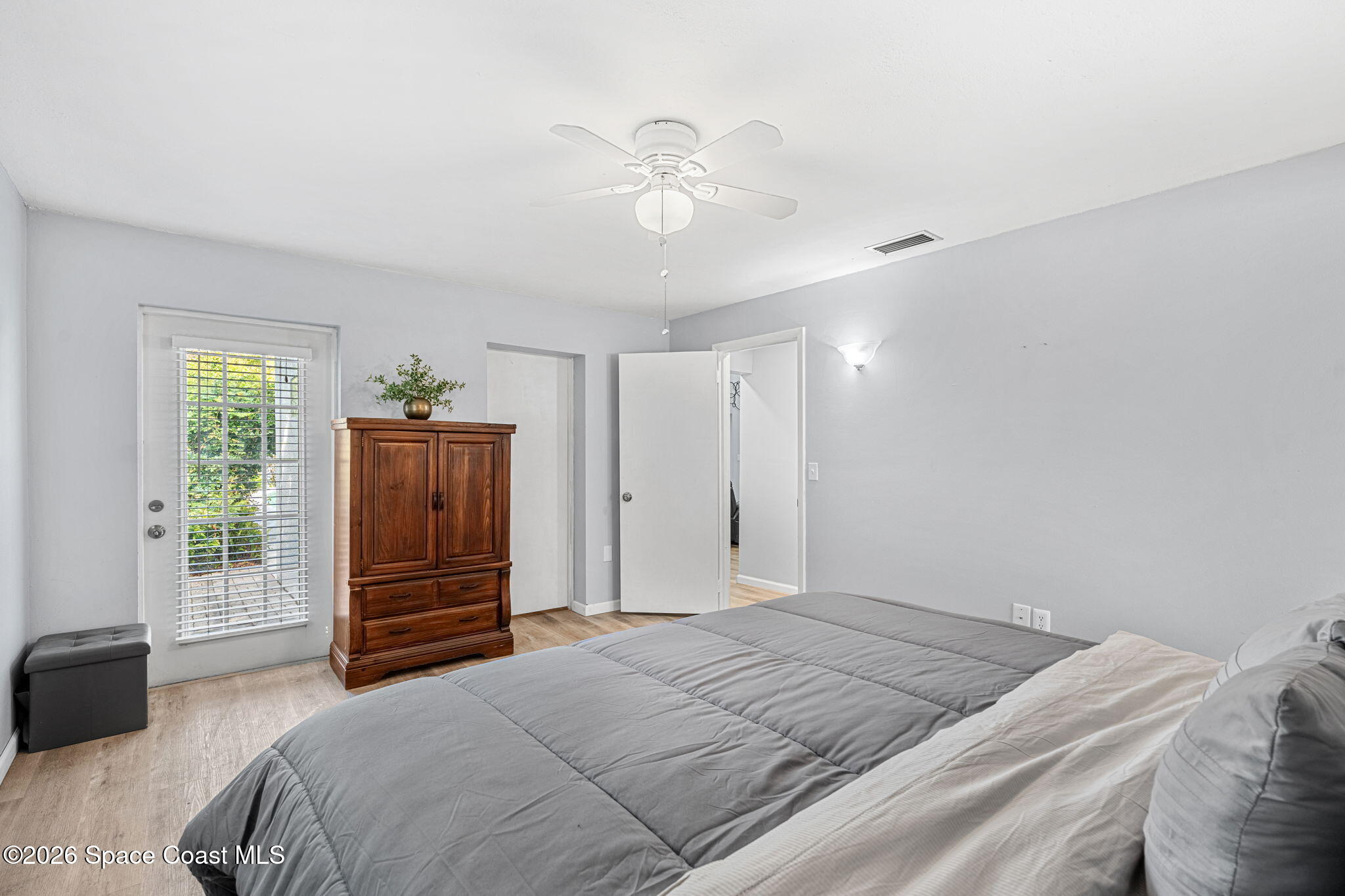 975 Oak Street Merritt Island, FL 32953 - Photo 42 of 76 a bedroom with a bed and a chandelier