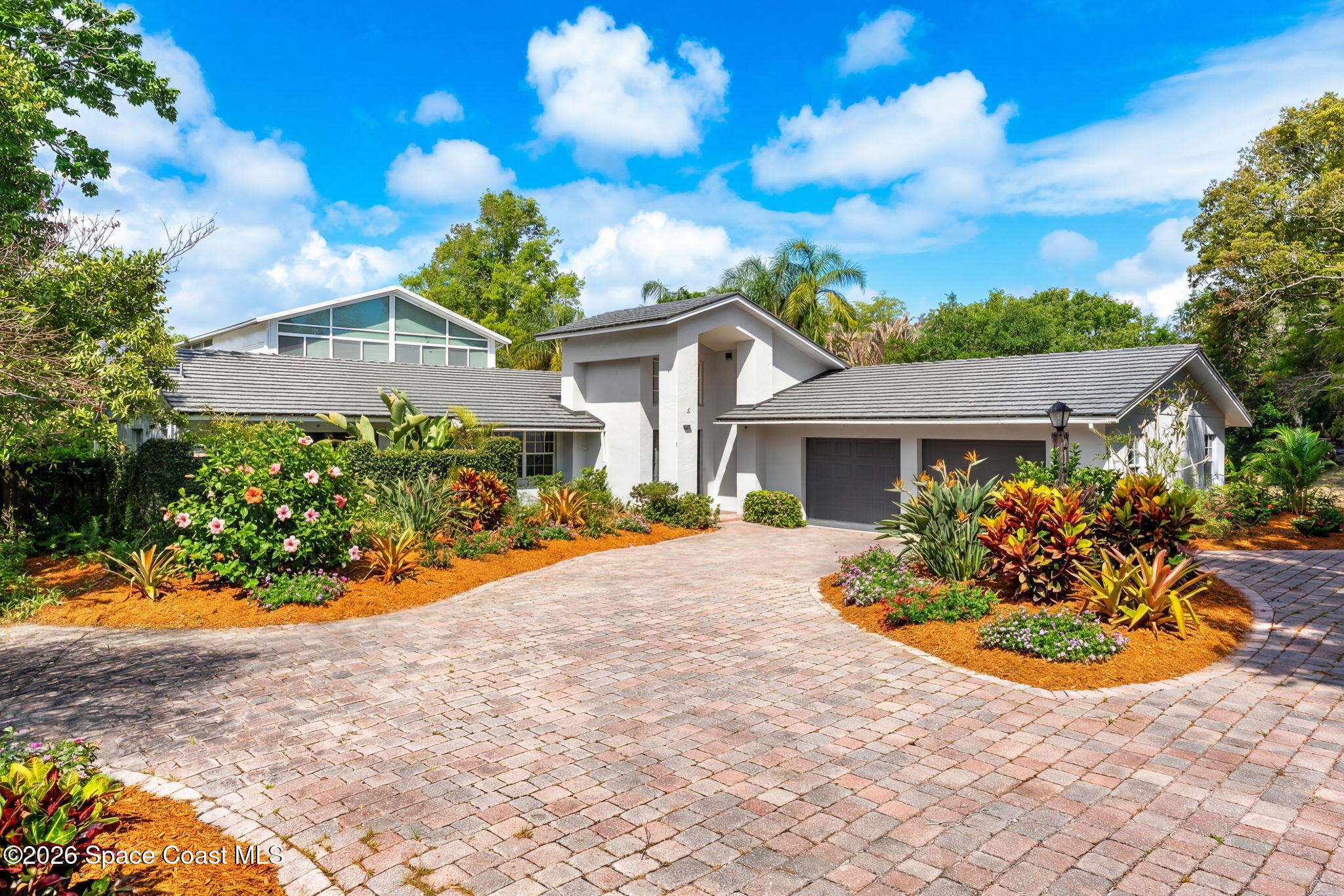 975 Oak Street Merritt Island, FL 32953 - Photo 5 of 76 a front view of a house with a yard and potted plants