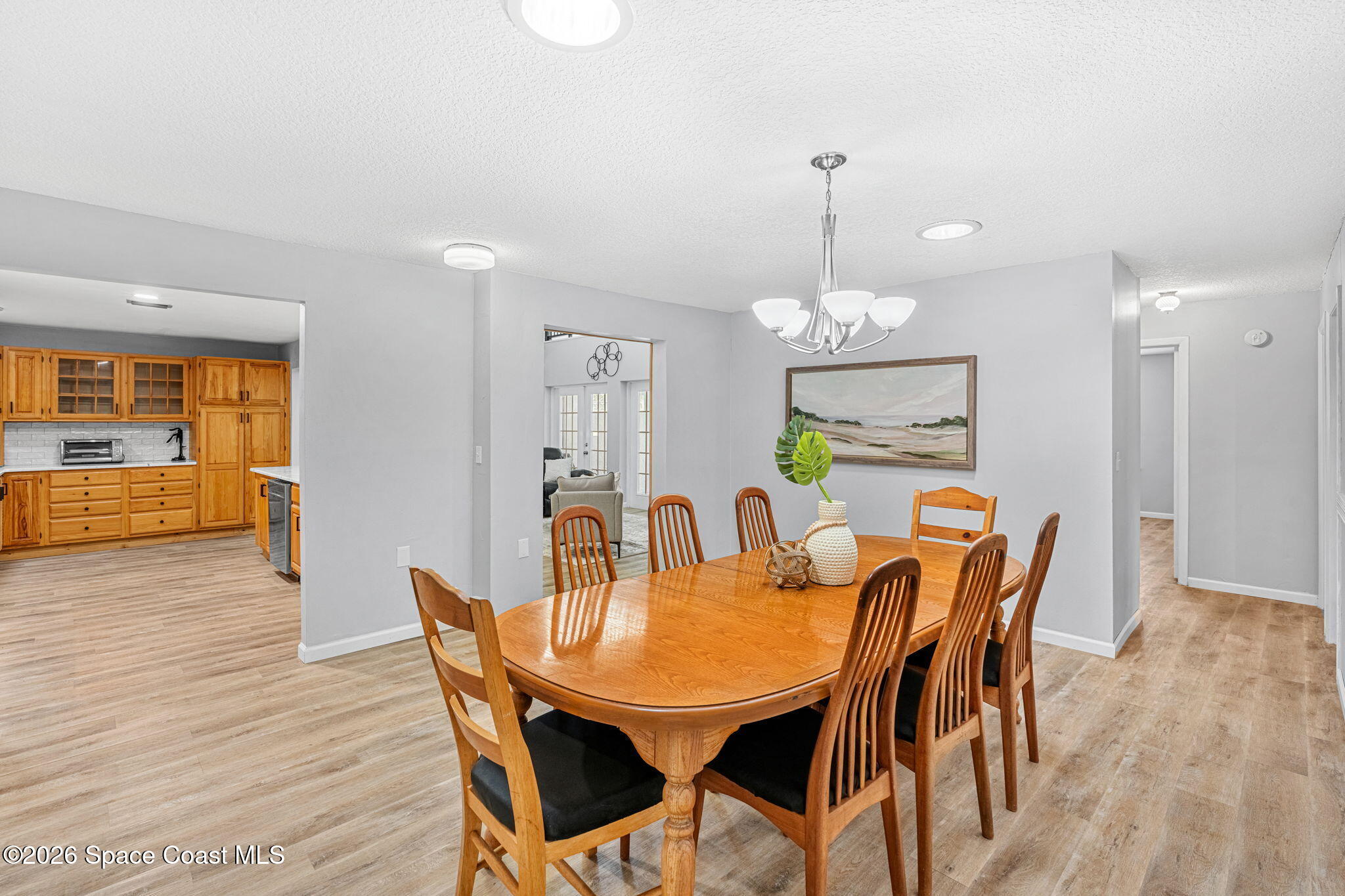 975 Oak Street Merritt Island, FL 32953 - Photo 7 of 76 a dining room with furniture a chandelier and wooden floor