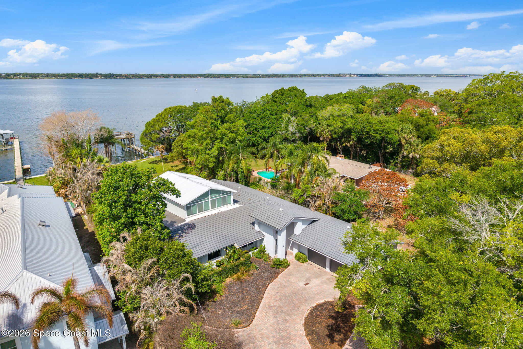975 Oak Street Merritt Island, FL 32953 - Photo 73 of 76 an aerial view of a house with outdoor space and a lake view in back