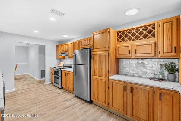 a kitchen with stainless steel appliances granite countertop a sink and cabinets