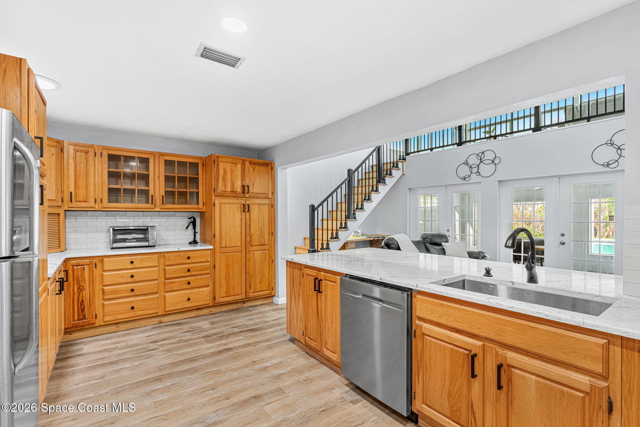 975 Oak Street Merritt Island, FL 32953 - Photo 10 of 76 a kitchen with stainless steel appliances granite countertop a sink and cabinets