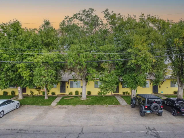 a view of a parked cars in front of a brick house