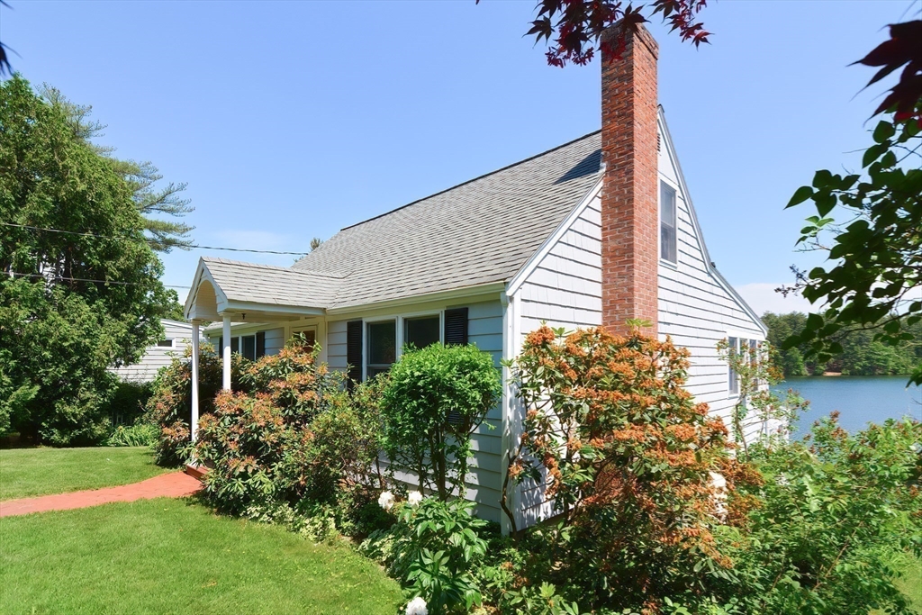 64 Pine Point Road Stow, MA 01775 - Photo 13 of 35 a front view of a house with garden