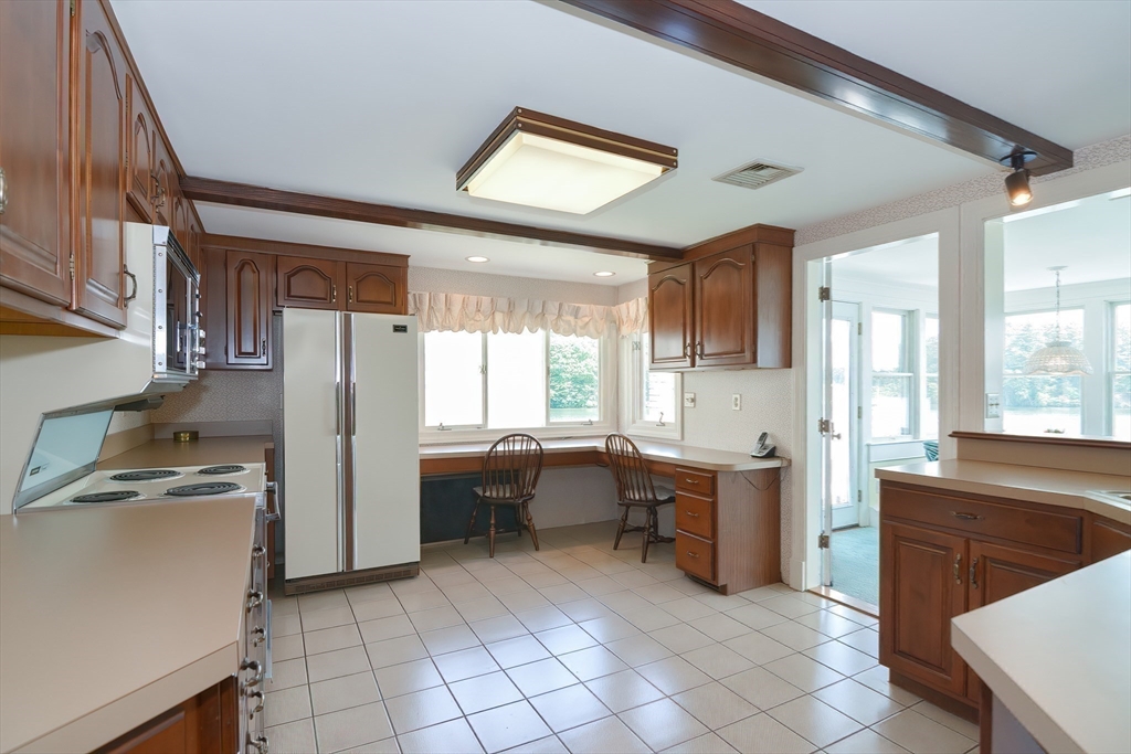 64 Pine Point Road Stow, MA 01775 - Photo 17 of 35 a kitchen that has a sink a stove and chair