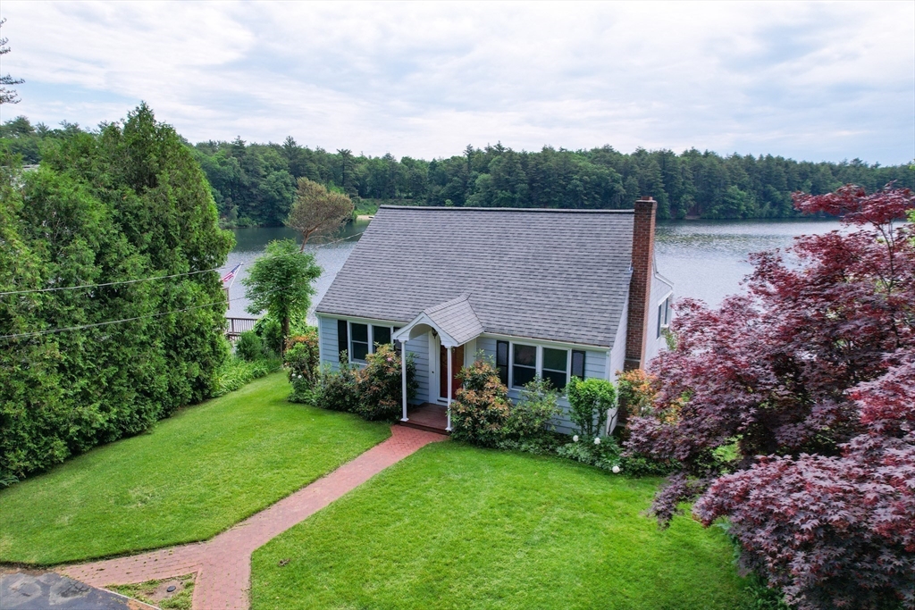64 Pine Point Road Stow, MA 01775 - Photo 34 of 35 a view of house with garden and trees in the background