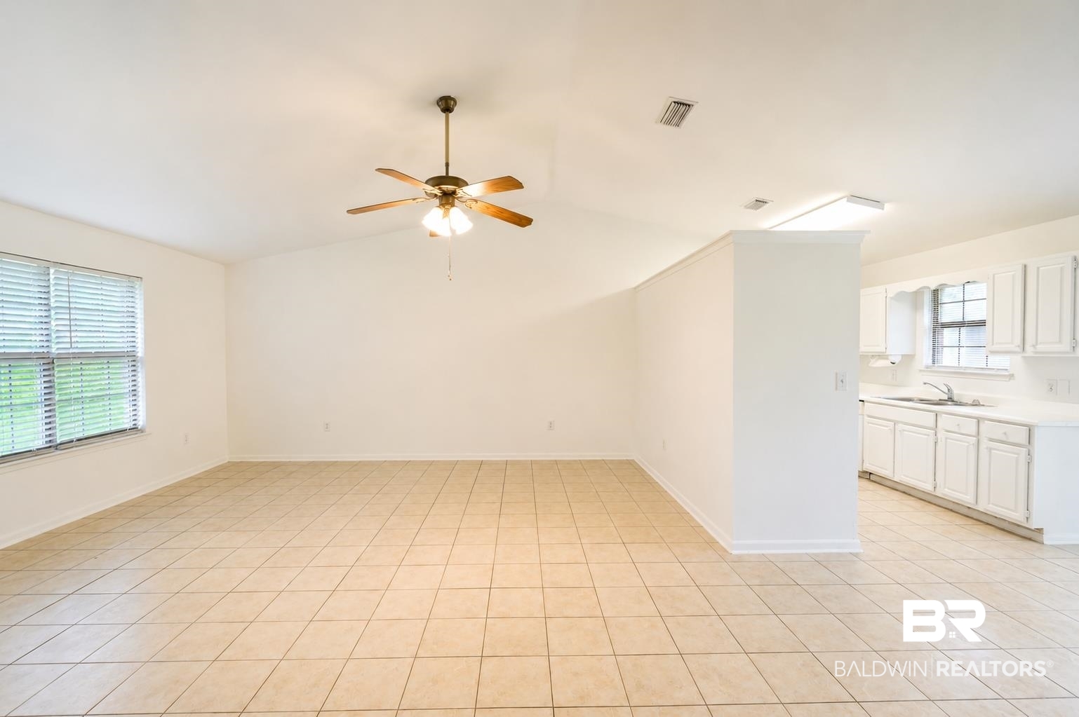 614 East Gate Circle Foley, AL 36535 - Photo 6 of 31 Open-concept living space featuring vaulted ceilings, tile flooring, and a ceiling fan with integrated lighting