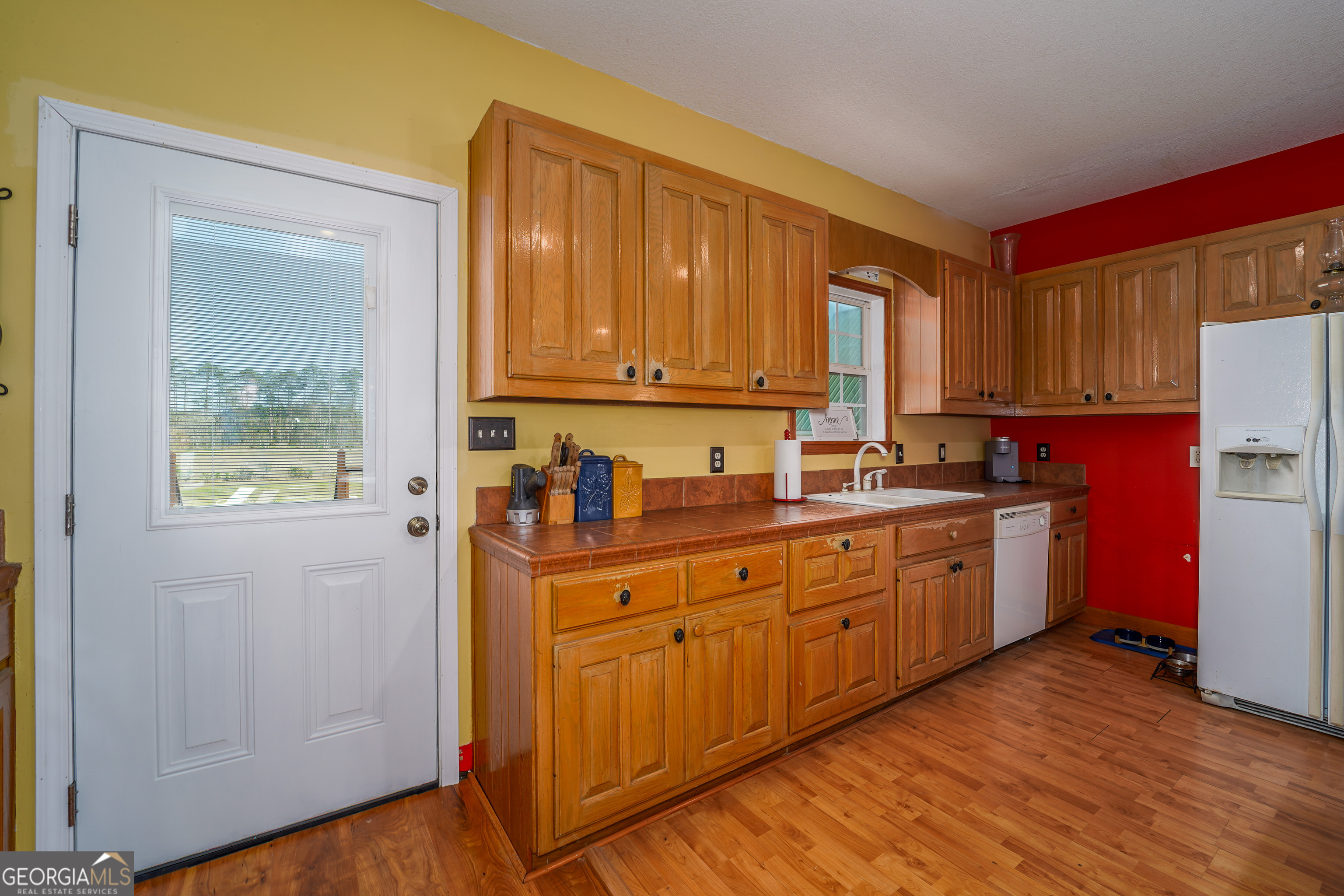 3300 Connor Lane Waycross, GA 31503 - Photo 24 of 42 a kitchen with sink refrigerator and cabinets
