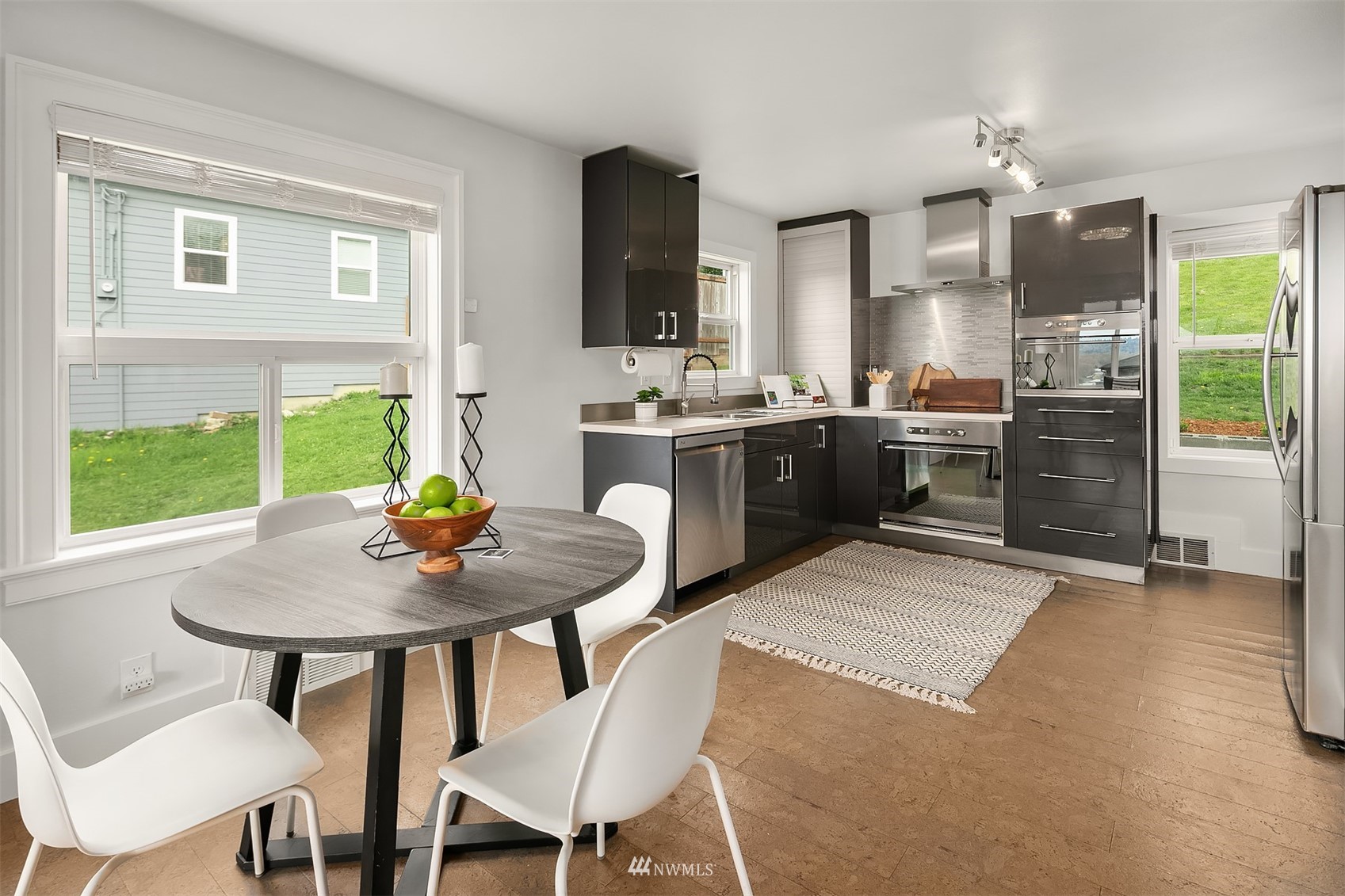 806 Cedar Avenue South Renton, WA 98057 - Photo 4 of 20 a kitchen with kitchen island a dining table and chairs