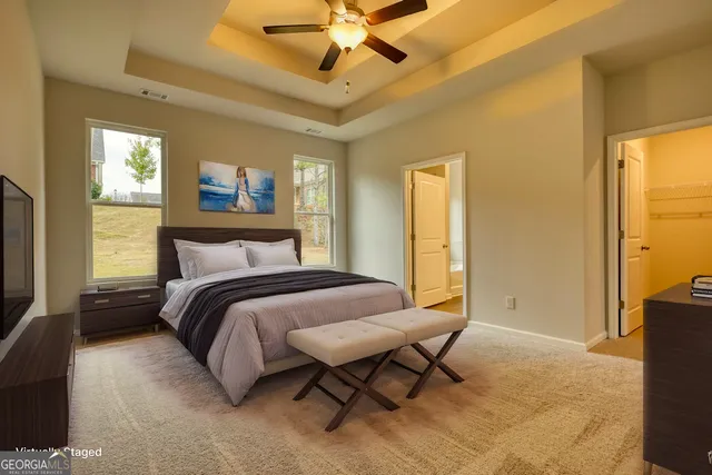 a bedroom with a bed and a chandelier