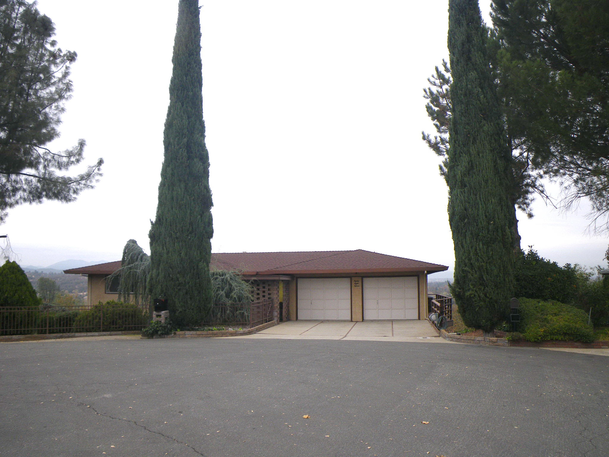 8815 Valley View Road Redding, CA 96001 - Photo 1 of 25 a front view of a house with a yard and garage