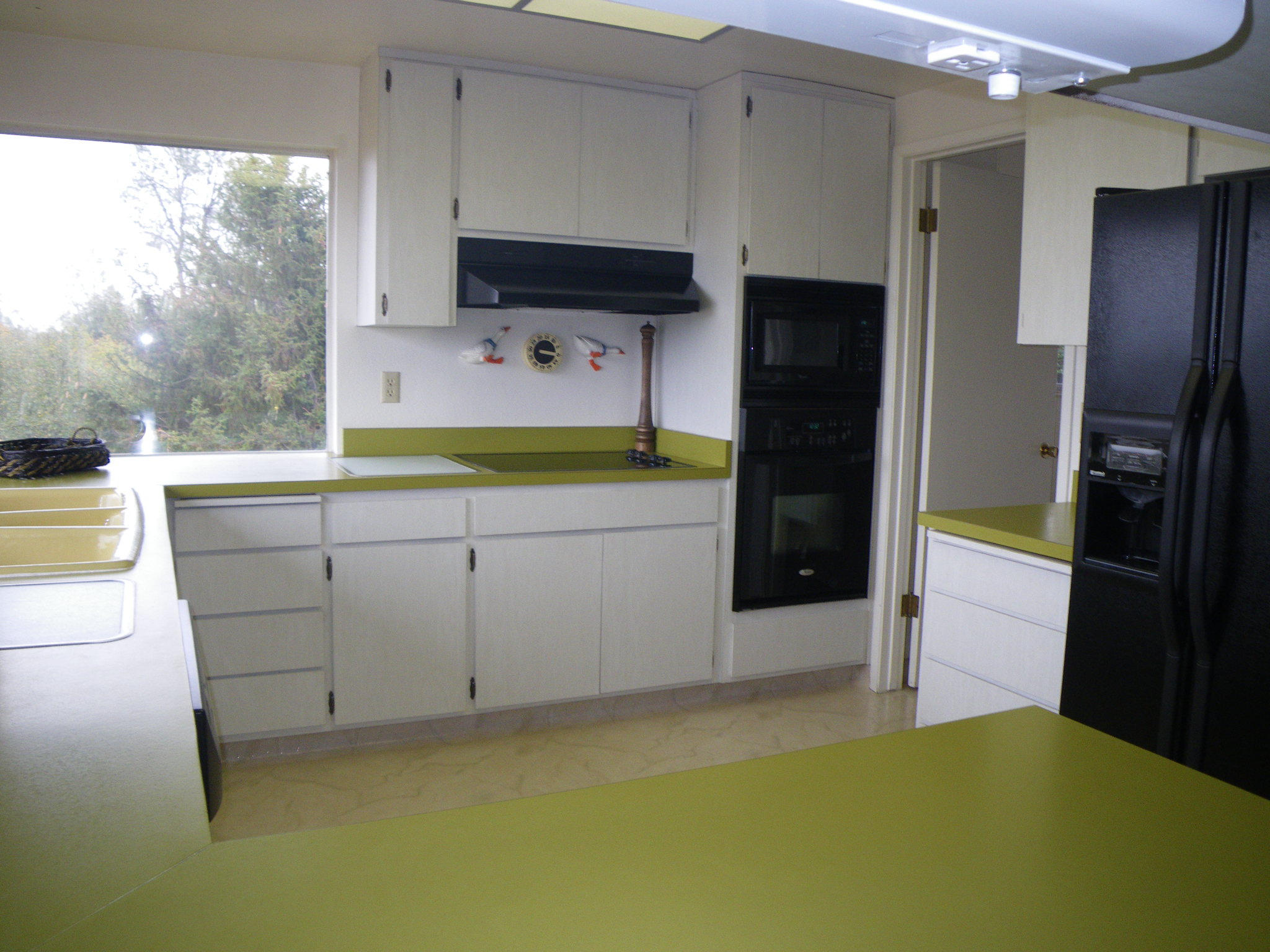8815 Valley View Road Redding, CA 96001 - Photo 5 of 25 a kitchen with a refrigerator and a stove top oven