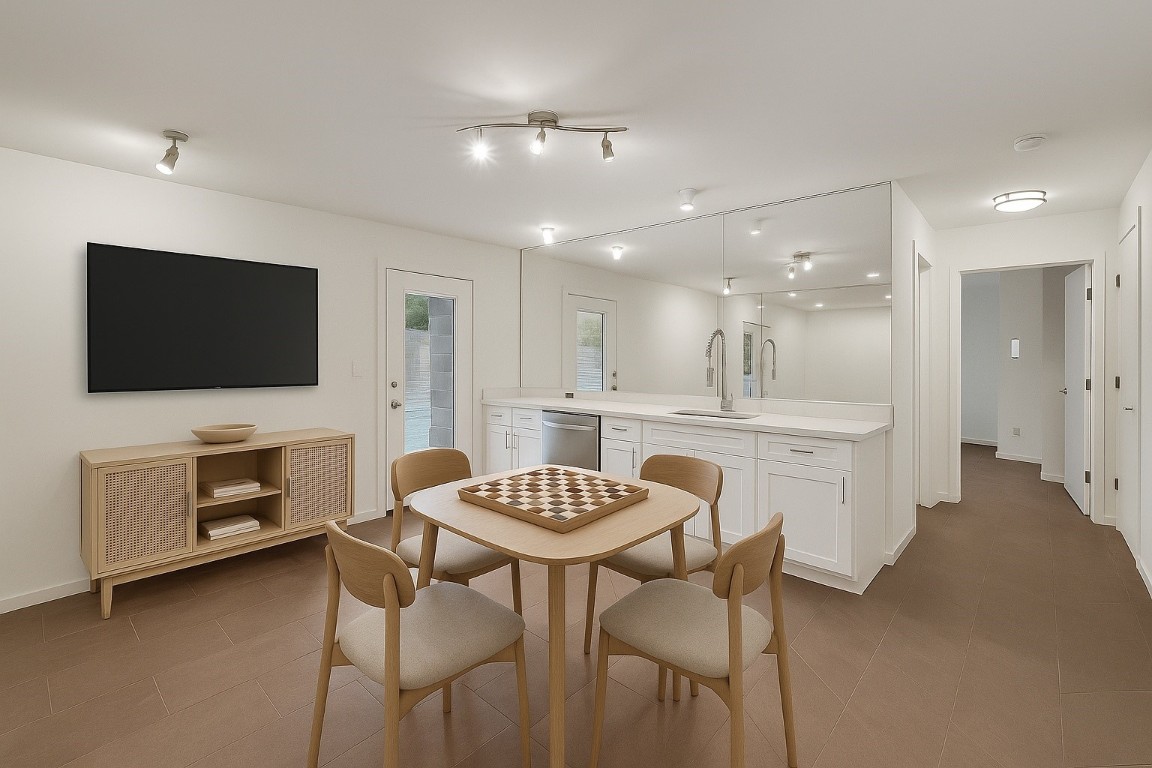 320 Detering Street Houston, TX 77007 - Photo 19 of 32 Downstairs game/family room area situated between the two secondary bedrooms, features tile flooring, wet bar with a sink, storage, and an ice maker. Door provides direct access to the private backyard and pool —ideal for easy indoor/outdoor flow.