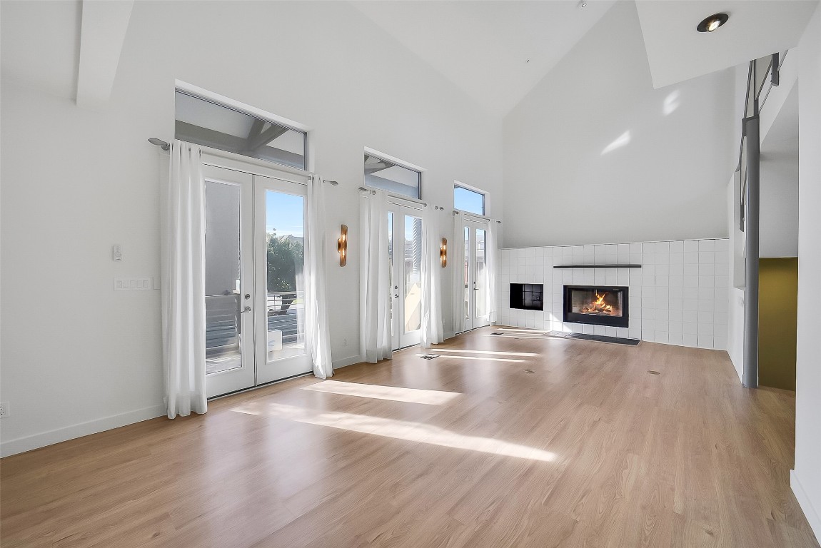 320 Detering Street Houston, TX 77007 - Photo 6 of 32 A view of the second-floor living area not staged to highlight the room’s scale and flexibility. This layout accommodates multiple seating arrangements and showcases the natural flow toward the balcony through the three French doors. Ideal for entertaining or comfortable everyday living. Large space can accommodate a dining space and living room area.
