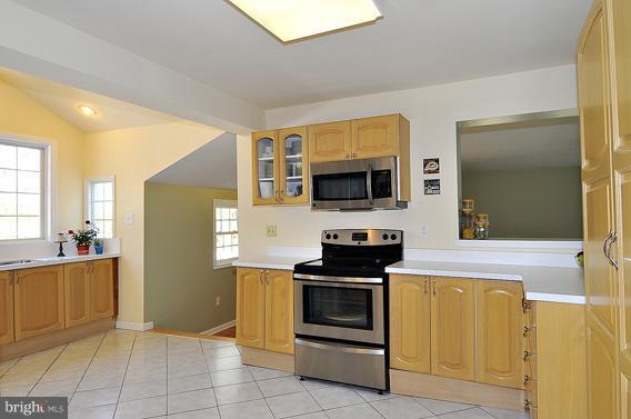 15310 Riding Stable Road Laurel, MD 20707 - Photo 19 of 27 a kitchen with stainless steel appliances a stove a microwave and a refrigerator