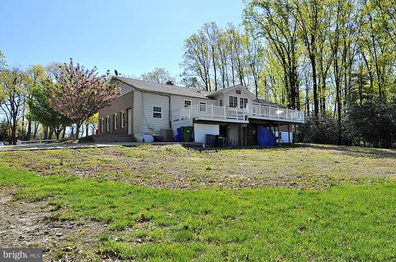 15310 Riding Stable Road Laurel, MD 20707 - Photo 22 of 27 a front view of a house with a yard garage and outdoor seating