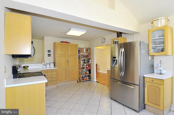 15310 Riding Stable Road Laurel, MD 20707 - Photo 23 of 27 a kitchen with a refrigerator a stove and a sink