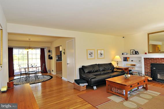 15310 Riding Stable Road Laurel, MD 20707 - Photo 7 of 27 a living room with furniture a flat screen tv and a fireplace