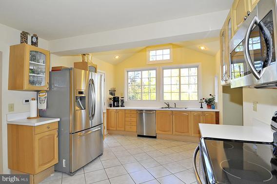 15310 Riding Stable Road Laurel, MD 20707 - Photo 8 of 27 a kitchen with stainless steel appliances a refrigerator sink and cabinets