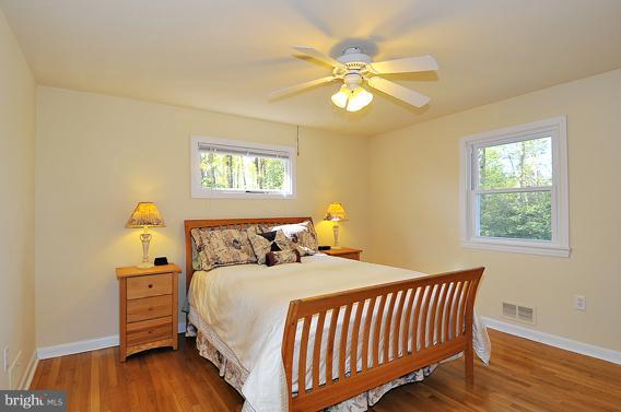 15310 Riding Stable Road Laurel, MD 20707 - Photo 9 of 27 a bedroom with a bed and wooden floor
