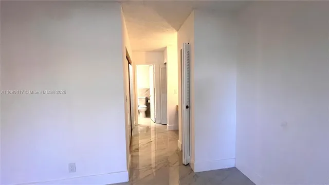 a view of spacious bathroom with bathtub and wooden floor