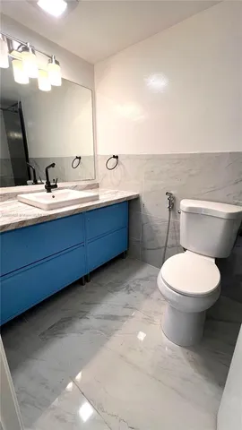 a kitchen with a refrigerator a stove top oven and cabinets